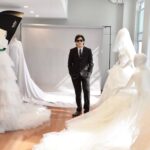 Guillermo Pharis standing with dresses