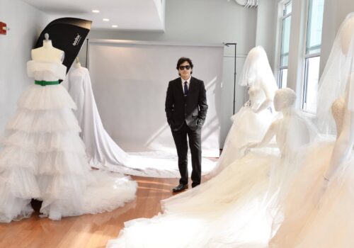 Guillermo Pharis standing with dresses